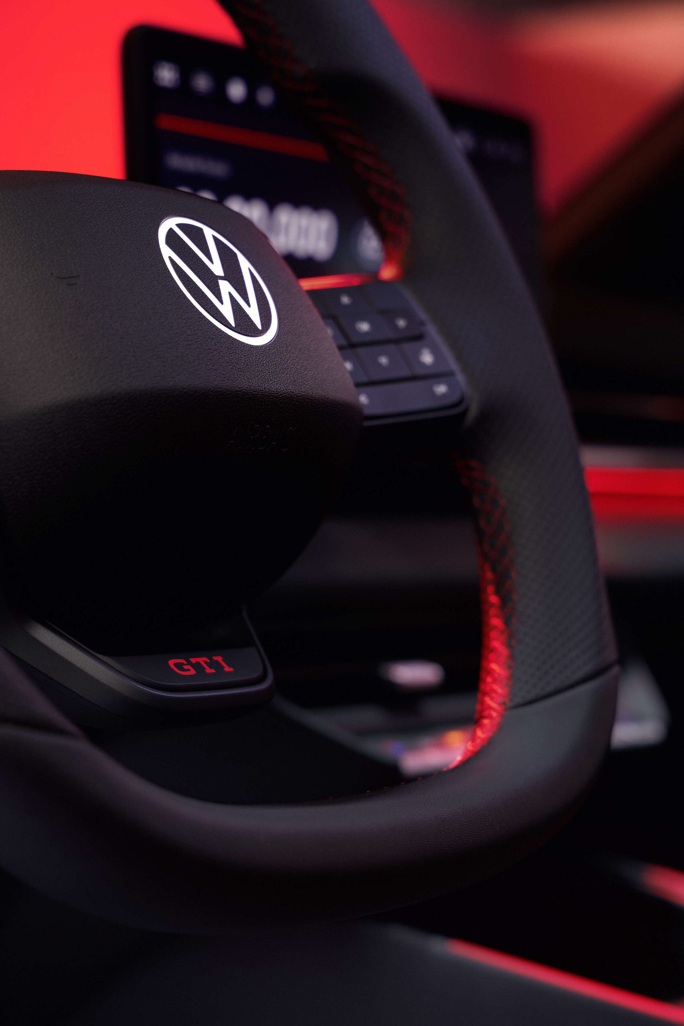 O volante integra marcador vermelho às 12 horas, botão GTI e comandos dedicados.